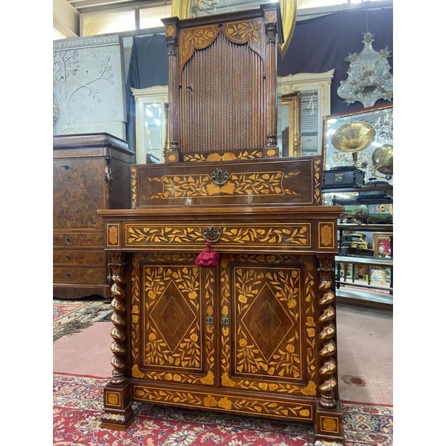 18th century Dutch furniture, a precise marquetry caresses and delicately touches the precious mahogany wood and the...