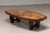 Exceptional coffee table featuring a beautifully geometric inlaid wooden top. In good condition.