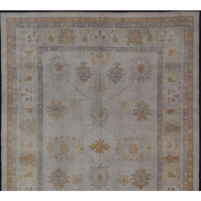 Measures: 10'6 x 14'0 Turkish Oushak Rug in Gray with Faded Gold, Taupe, and Dusty Blue 10'6 x 14'0. Keivan Woven Arts....