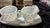 This is a vintage milk glass creamer and sugar set featuring a hobnail pattern. The set includes two pieces with a...