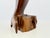 A vintage hand-carved wood dolphin sculpture with a graceful, elongated form and rich dark brown finish. The dolphin rises...