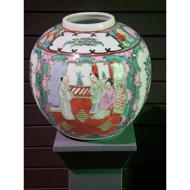 This vintage Asian Chinoiserie Famille Rose vase is a beautifully hand-painted piece featuring intricate figural and...