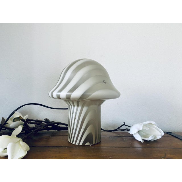 This unique mushroom design table lamp from the 1970s was designed by Peill & Putzler. It is made of mouth-blown Murano...