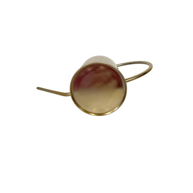 Vintage minimalist artistic flair brushed gold tone metal watering can. Measures 16” at the widest point x 5.25” diameter...