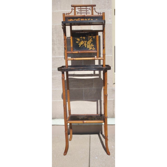 Antique 19th-century bamboo lacquered display stand made in France. The Japaned panels are painted in gilt floral sprays;...