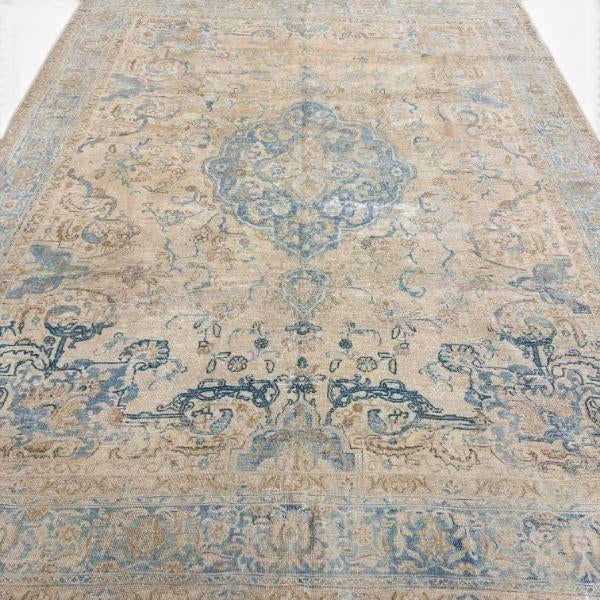 This elegant antique Tabriz rug features a refined central medallion surrounded by traditional floral and decorative...