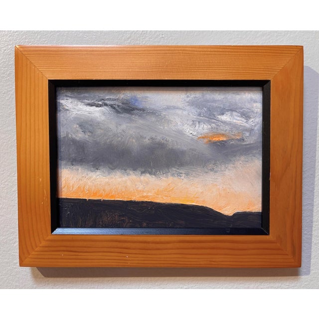 The artwork depicts a dramatic sundown over the Platte River, with a striking contrast between the dark silhouette of the...