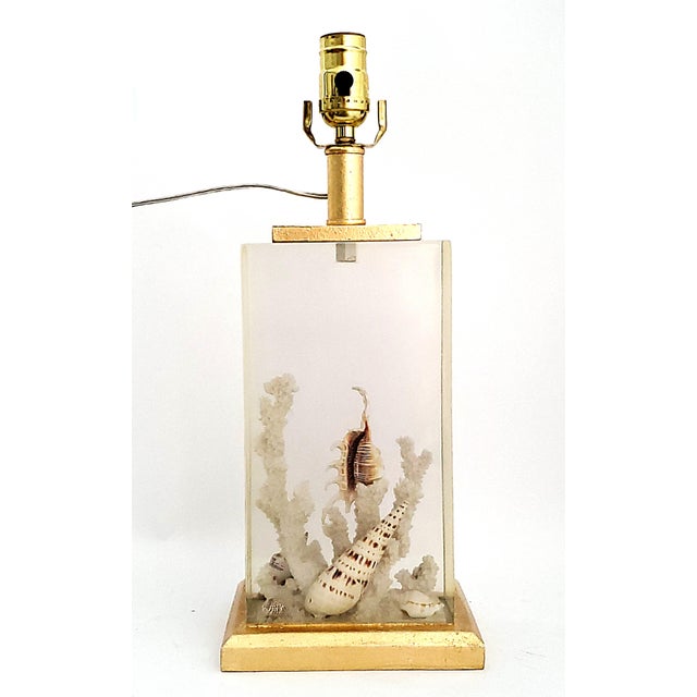 Offering a vintage French style Lucite resin seashell table lamp with original vintage raw silk shade, circa 1980s. This...
