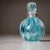 Set of elegant bottles in turquoise Murano glass, crafted in the Hollywood Regency style. The bulbous vessels feature a...
