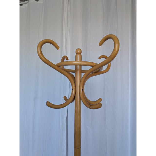Vintage bentwood coat stand crafted from light wood (likely beech). The design features gracefully curved hooks and a...