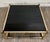 This is a stunning vintage Maison Jansen style Hollywood Regency coffee table featuring a brass-tone metal frame, smoked...