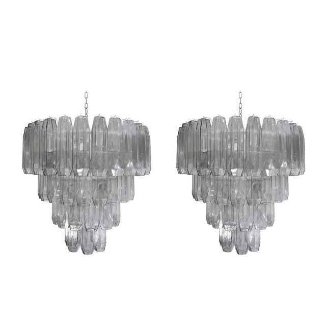 A good elegant pair of midcentury style ceiling lights, blown clear glass components in an elongated poliedri shape on a...