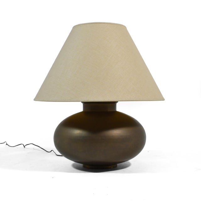 A design of subtle beauty, this table lamp has a brass base with a pleasing orb shape and a rich patina from age....