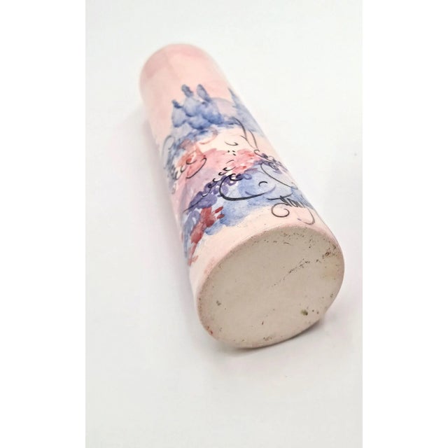 This gorgeous piece of studio pottery is hand-painted and signed by the artist. Lovely florals in pinks and purples add a...