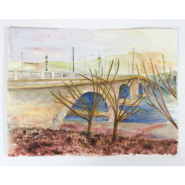 Late 20th century watercolor on paper painting of a river bridge and landscape. Unsigned. Unframed.