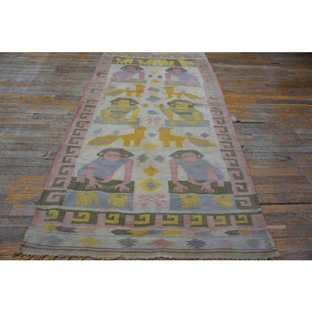 Antique Dhurrie Small Scatter Size Cotton Ivory Rug, Circa Date: 1920s. This extraordinary example of folk textile art...