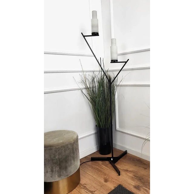 Beautiful Italian, in typical Mid-Century Art Deco style, two-armed floor lamp in black metal with brass details and...