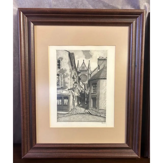 A charming matched pair of mid-20th-century black-and-white etchings depicting iconic views of Notre-Dame de Chartres...