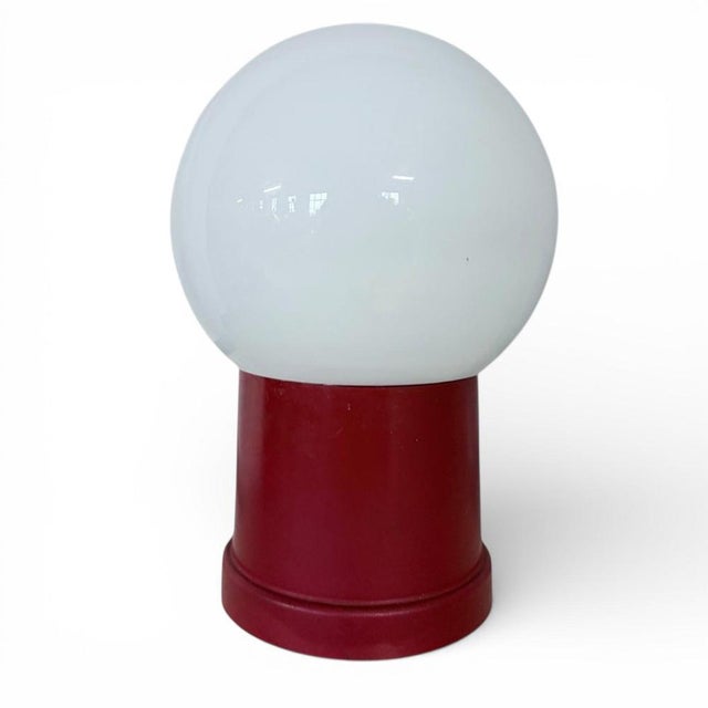 This vintage space age lamp features a bold red mushroom lamp base paired with a smooth opaline glass shade, delivering...