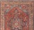 This antique Persian Heriz rug features an all-over sub-geometric medallion design rendered in multicolor, set upon a red...