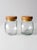 This pair of vintage glass jars offers versatile storage with a timeless design. Featuring a rounded shape with flat...