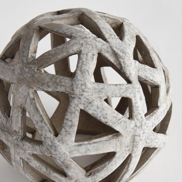 This contemporary little orb is made of thin ceramic strips giving it an open and airy feel. It is perfect in a wide open...
