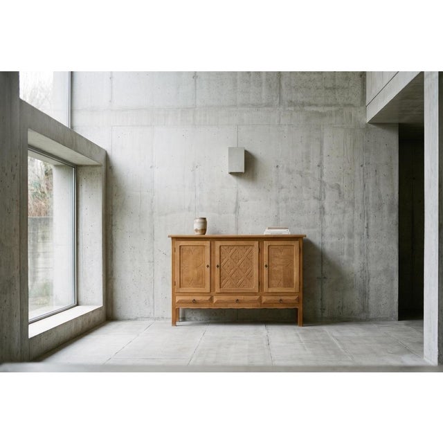 Oak sideboard attributed to Danish designer Henning Kjærnulf, crafted in Denmark during the 1960s. Executed in a Brutalist...