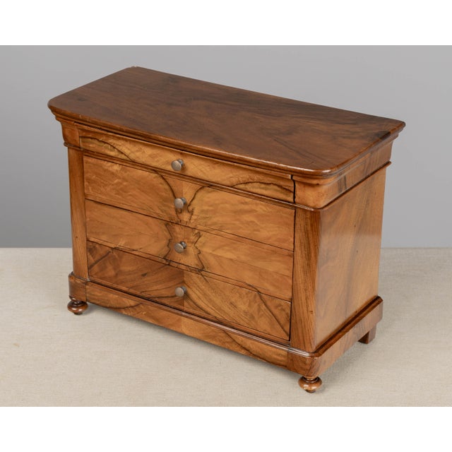 A fine 19th century French Louis Philippe Period miniature commode, or sample chest. Hand-crafted of solid walnut with...