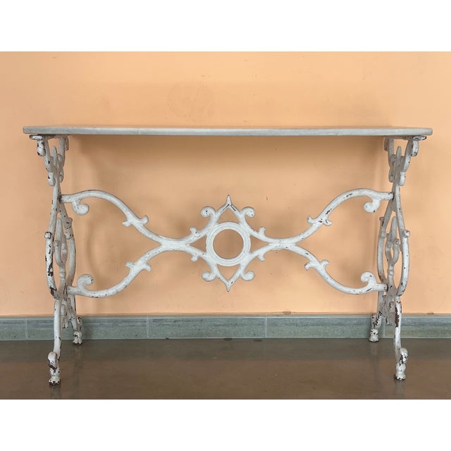 Antique cast iron French pastry style black scrolling "Butterfly" coffee table with marble top. Item features impressive...