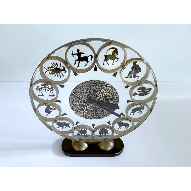 Very large Zodiac Theme Clock from the 1950s featuring a bakelite base, brass dial with cut out zodiac signs, center...