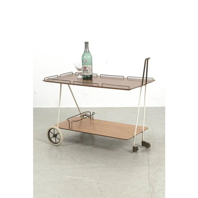Beautiful trolley from Germany with 2 different coloured trays, messing details and white frame. It has some traces of use...