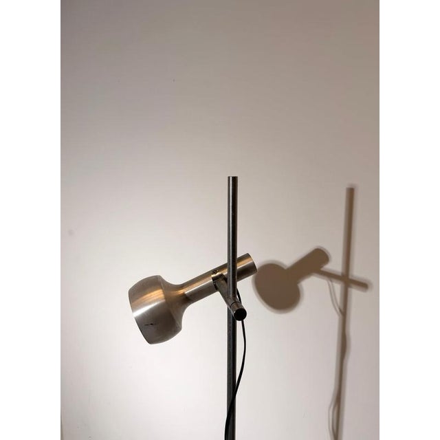 Sleek vintage floor lamp featuring two independently adjustable spot heads mounted on a slim chrome pole. A classic...