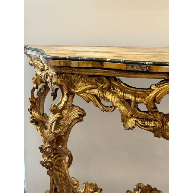 18th century Roman console carved and gilded with a veneered marble top. The gilding is original