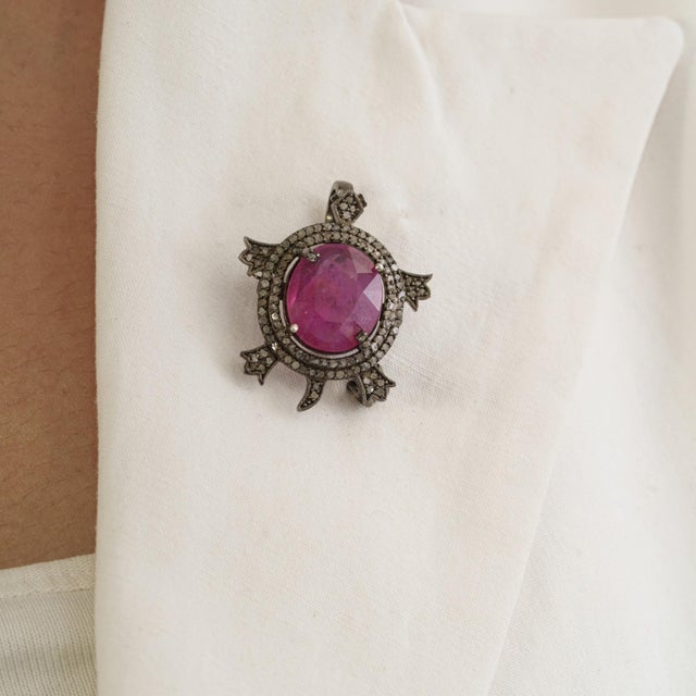 The Antique-Style 8 Ct Glass-Filled Ruby & Diamond Pavé Turtle Brooch Pendant is crafted in 925 sterling silver and...
