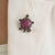 The Antique-Style 8 Ct Glass-Filled Ruby & Diamond Pavé Turtle Brooch Pendant is crafted in 925 sterling silver and...