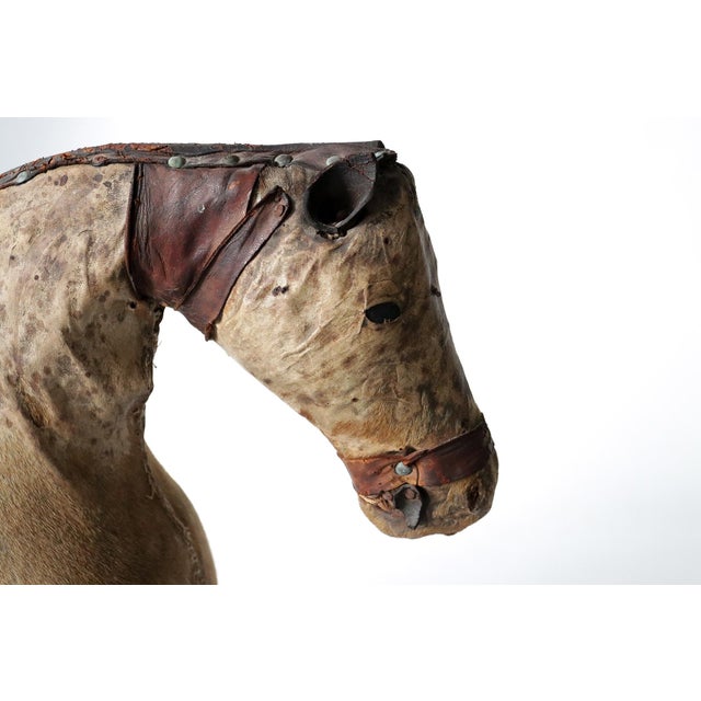 This striking decorative horse sculpture was crafted in France around 1880 and is covered in genuine horsehide, with...
