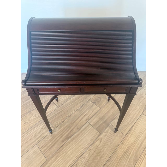 Elegant and highly decorative, this vintage Bombay secretary desk features a distinctive tambour roll-top design that...