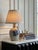 An exceptional example of American folk art craftsmanship, this vintage salt-glazed stoneware jug table lamp was...