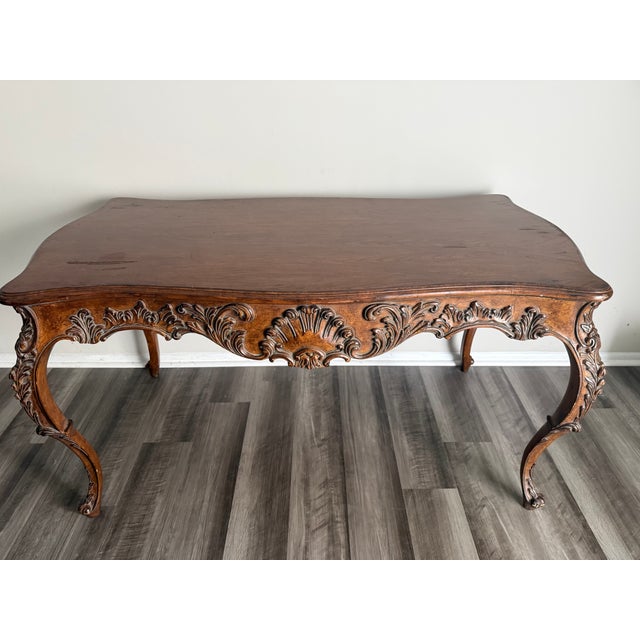 A beautiful and ornate writing desk in the Rococo/Louis XV style from the 1960s. It has a single hidden drawer in the back...