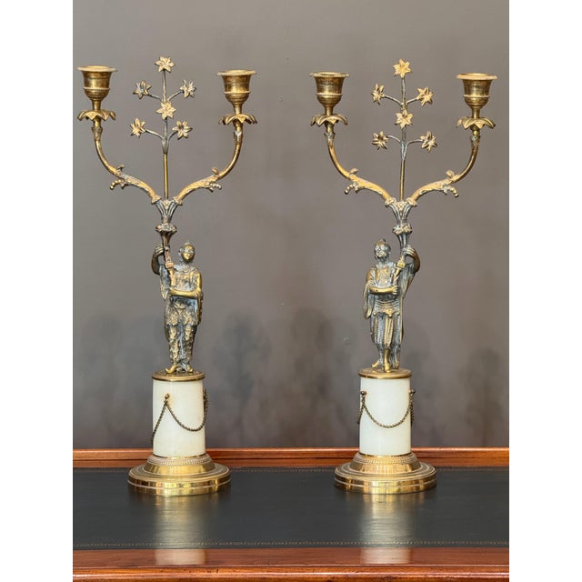 Pair of English Regency gilt bronze two-light candelabra, circa 1810, each cast as a chinoiserie figure, one male and one...