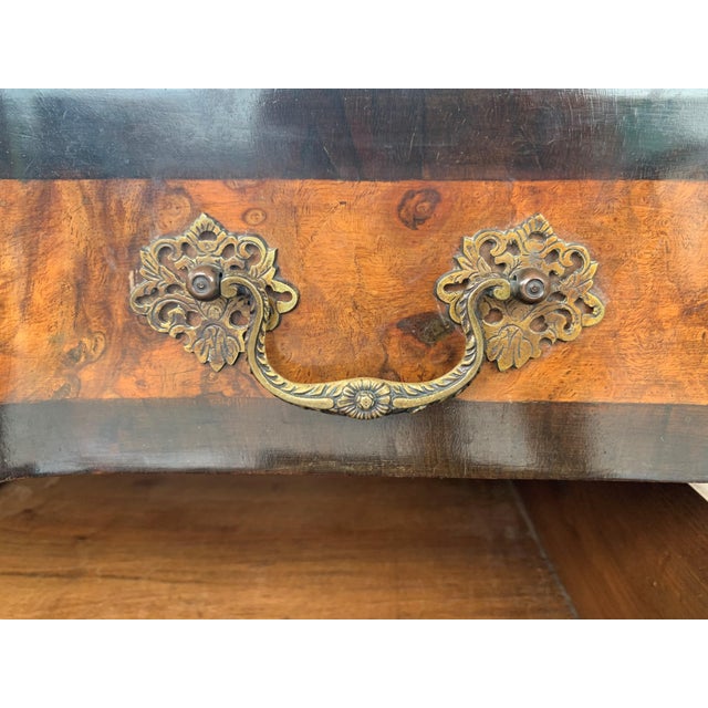 A elegant serpentine Venetian 1900s Baroque commode chest of drawers in ebonized hand carved walnut and walnut veneered,...