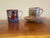 A charming grouping of teaware featuring hand-painted motifs. Includes a bold red cup with crane and wave imagery and a...