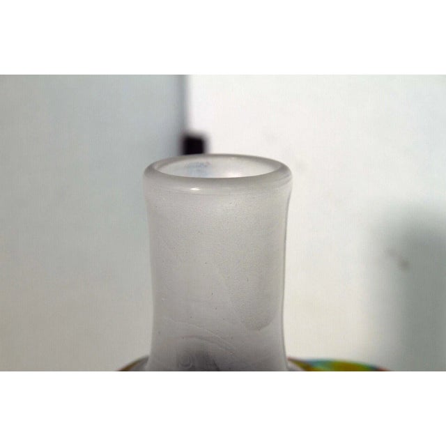 A stunning postmodern iridescent glass decanter with a flower design topper by Paula Barton. Signed and dated 1979 on the...