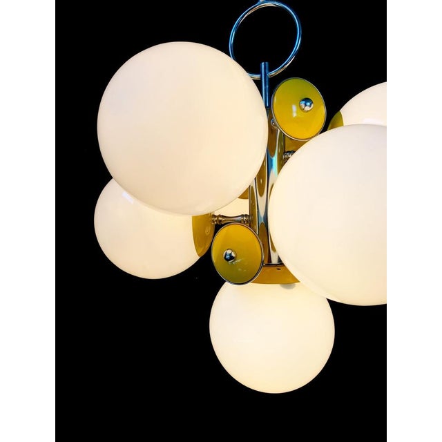 Beautiful chandelier with 7 lights attributed to Stilnovo. It is a warehouse background, it does not have many signs of...