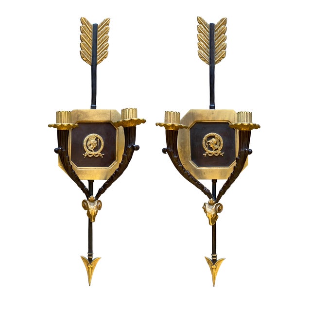 Fabulous pair of candle sconces with Neoclassical elements, handcrafted with a gilt and patinated bronze finish. The...