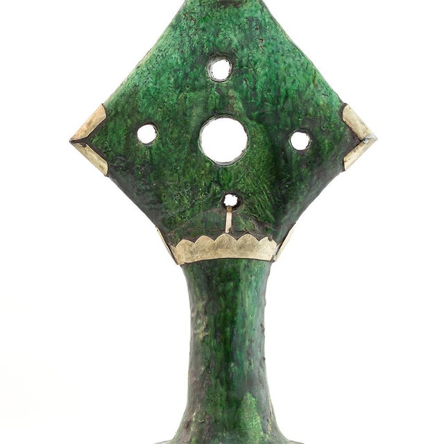 This hand-crafted Tamegroute candle holder showcases a distinctive geometric silhouette accented with circular cut-outs...