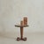 A French round pedestal accent table from the 1950s, crafted from solid wood. The circular top rests on a tapered central...