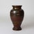 An antique Japanese vase from the Meiji Period, circa 1910, crafted from bronze with intricate mixed metal applications....