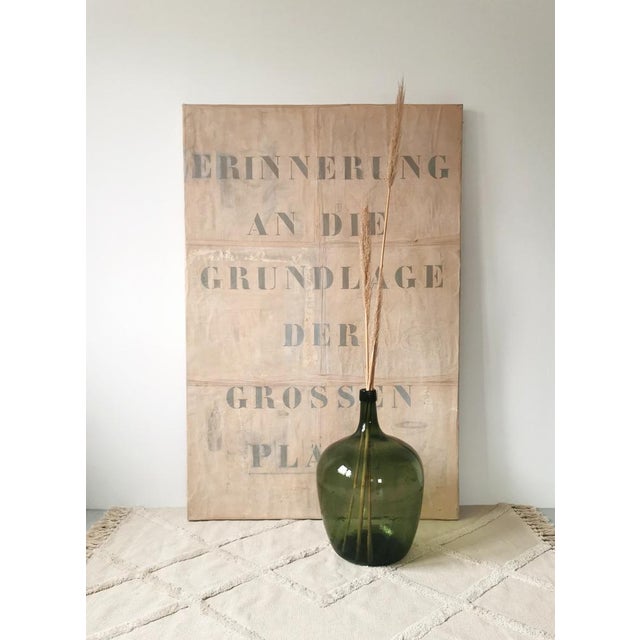 This very large, green glass balloon was made in Italy in the 1950s. These vessels were primarily used for storage in...