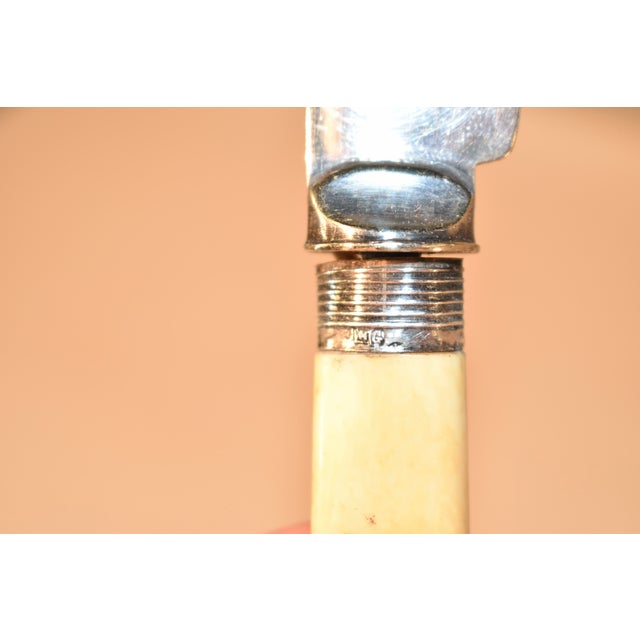 Hallmarked 1901 Sheffield silver cake knife with an ivory handle. The blade has a serrated edge and is engraved with a...